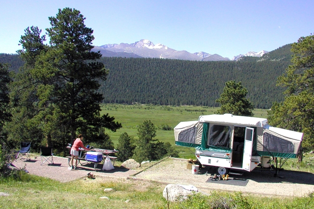 A group is camping with a pop-up camper