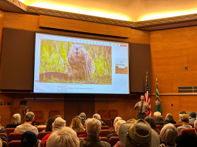 A park ranger is leading a program