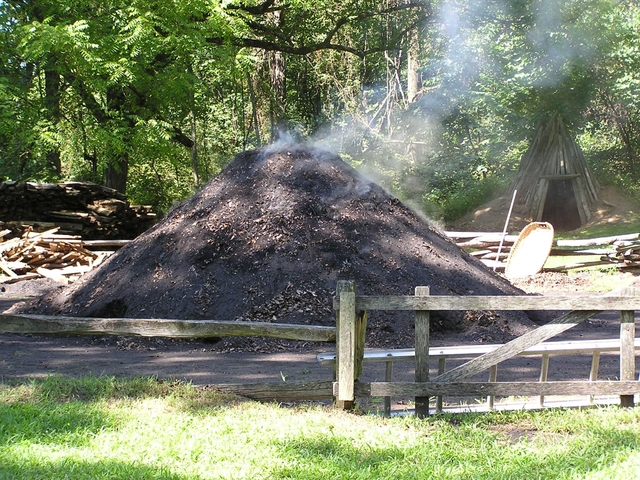 Demonstration charcoal pile smoldering.