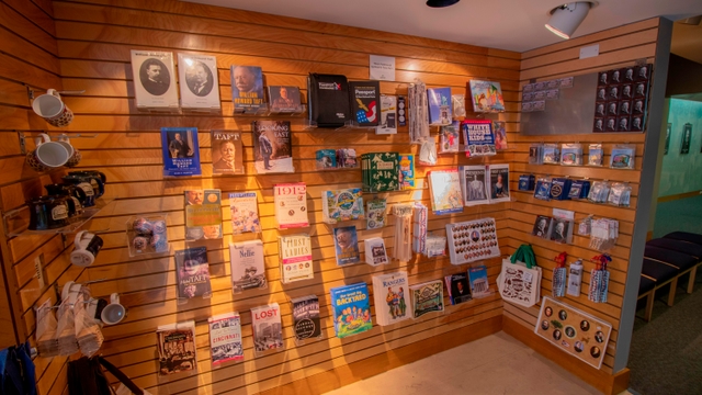 Several books and gift items arranged in rows on slotted walls