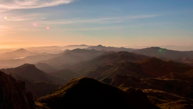 Mountain silhouettes at sunrise.