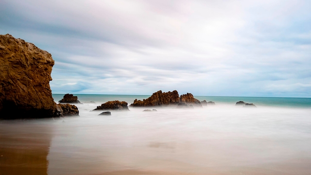 Rocks emerging from ocean.