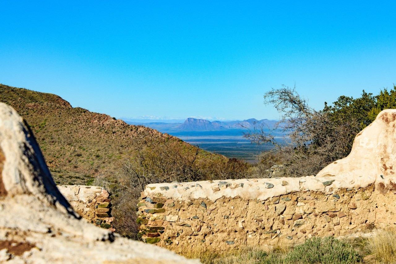 Ruins of the fort with mountains and valley in the background.