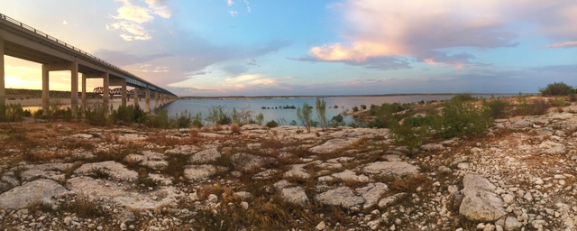 Sunset over Amistad Reservoir with Highway 90 bridge to left of photo going over the reservoir and i