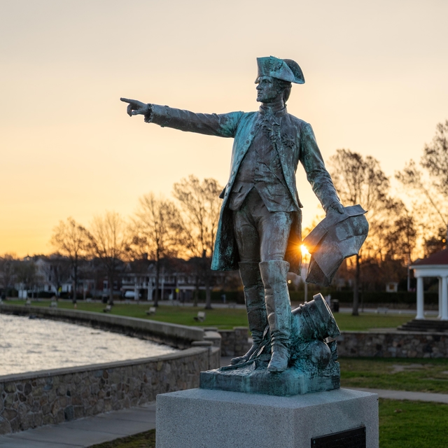 Bronze statue of Rochambeau pointing near the Newport waterfront.