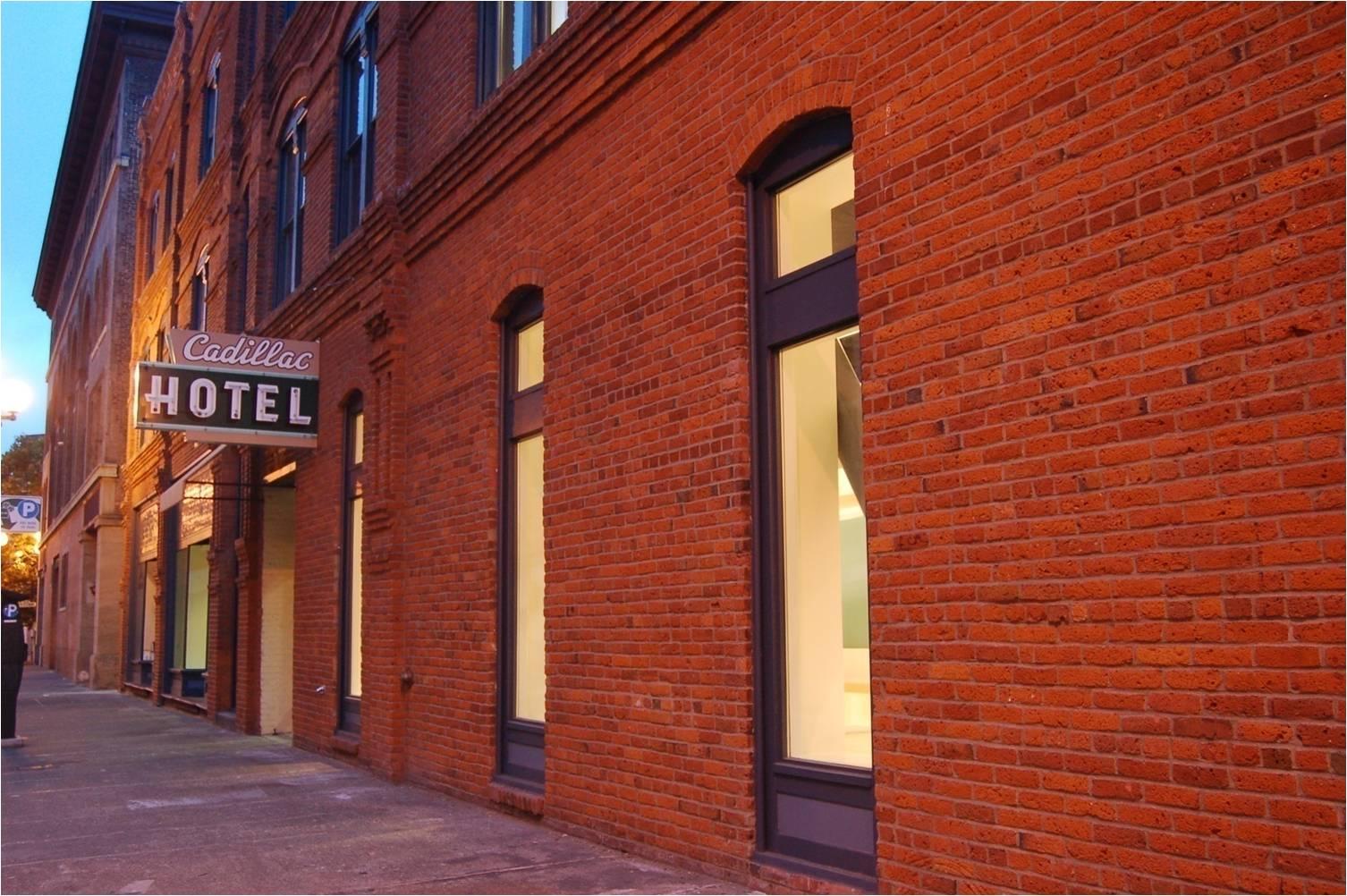 Large brick wall with glass windows.