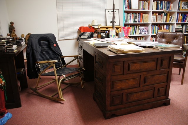 A chair and desk near bookshelves