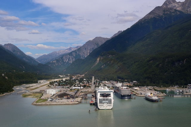 Aerial view of town in a valley with cruise ships in port