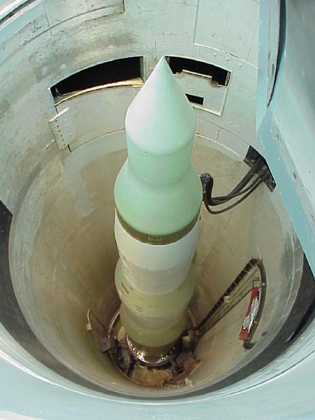 A cylindrical missile inside an underground silo.
