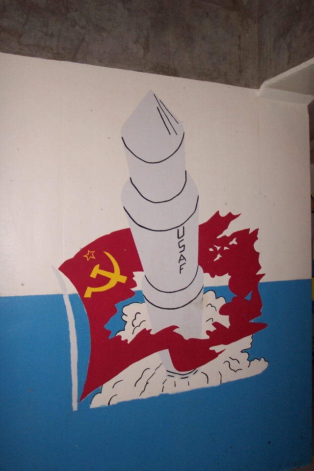 A painting of a nuclear missile bursting through a Soviet Flag