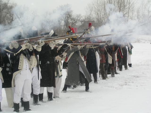 re-enactors firing in a battle line