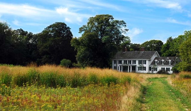 A view from a meadow of the historic Old Mastic House