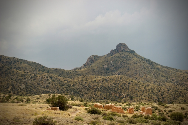 Ruined walls of the old buildings and mountains in the background