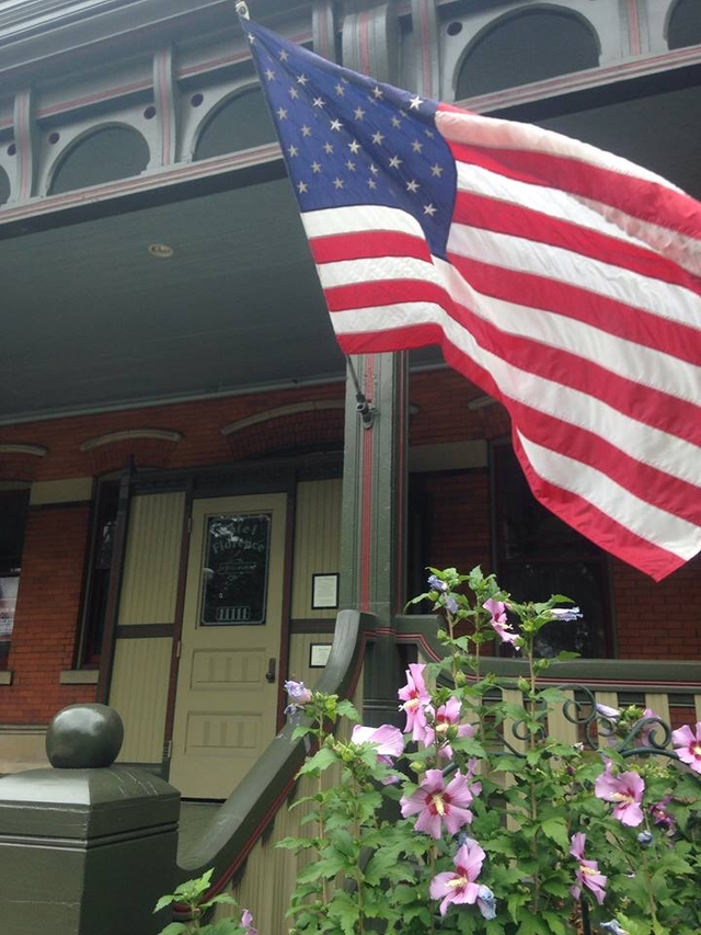 American flag flying on front porch.