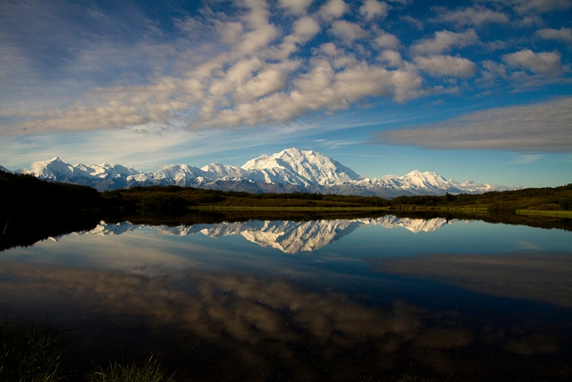 snowy mountains reflected in a pond