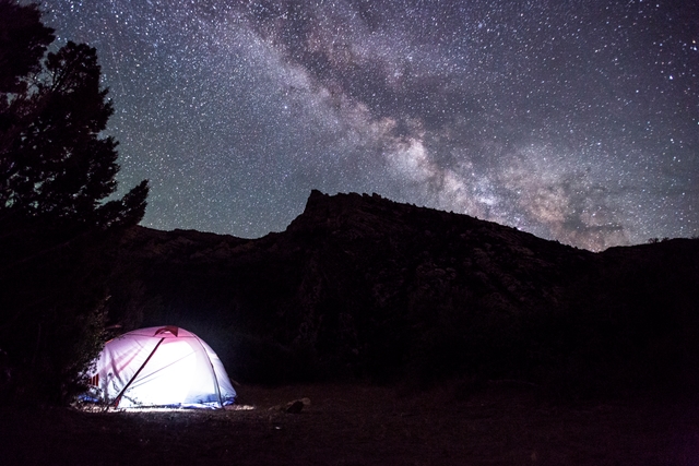 the star filled sky above a tent