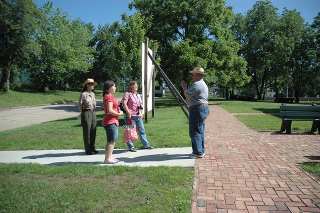 Visitors join a national park program around the Monroe school building and grounds