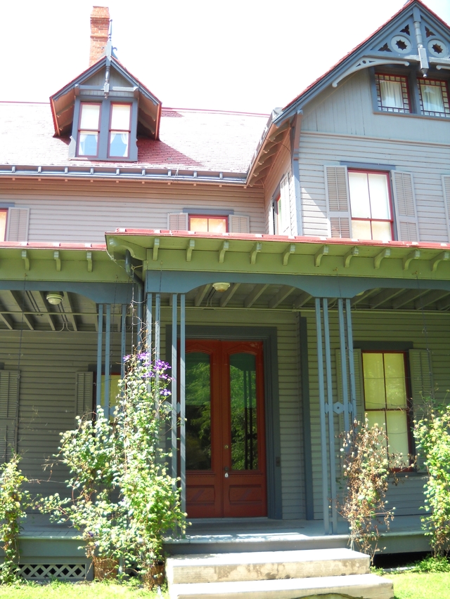 Front porch of Garfield home showing red front door