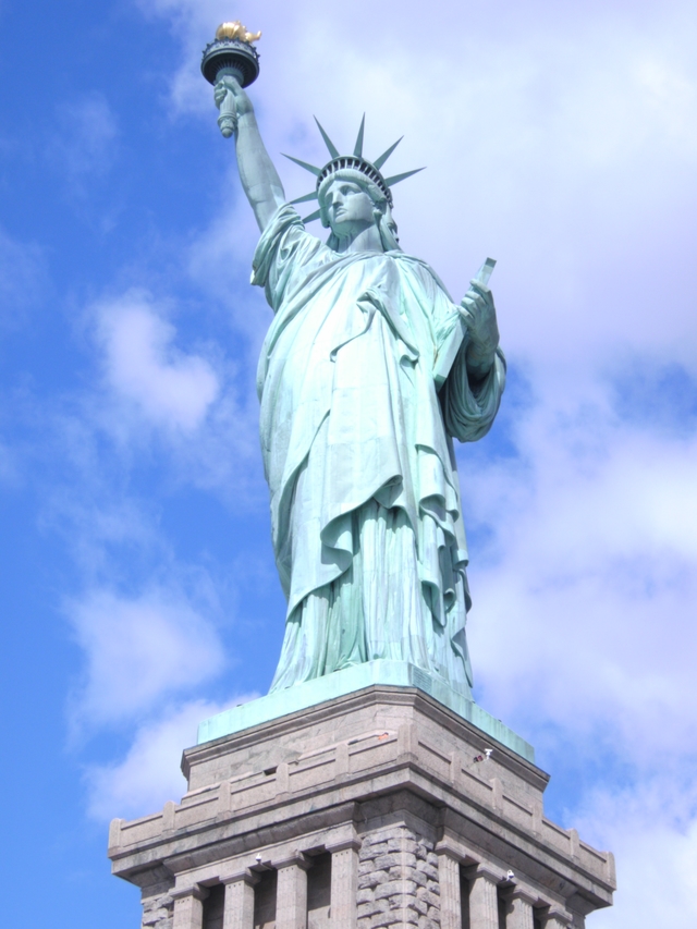 Entire patina green Statue of Liberty and very top of granite pedestal