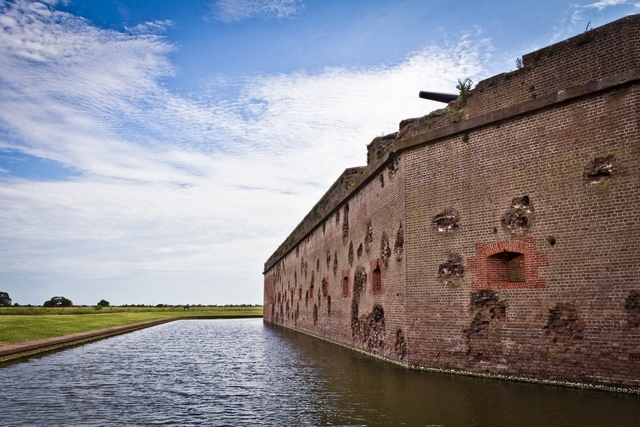 The red masonry walls of Fort Pulaski still show battle damage over 150 years later.