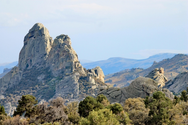 Two granite pinnacles right next to each other that are similar in size and shape.