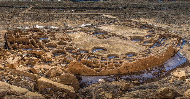 An aerial view of the Pueblo Bonito great house showing many rooms and circular kivas.