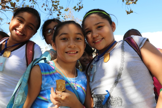 Kids stand holding their Anza Trail Junior Ranger badges