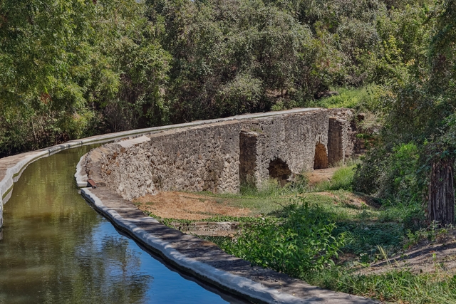 stone aqueduct with water filling the channel