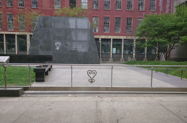 Outdoor memorial entrance with closed gate.