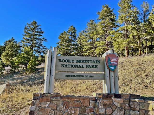 Rocky Mountain National Park Sign on a sunny day with clear sky overhead