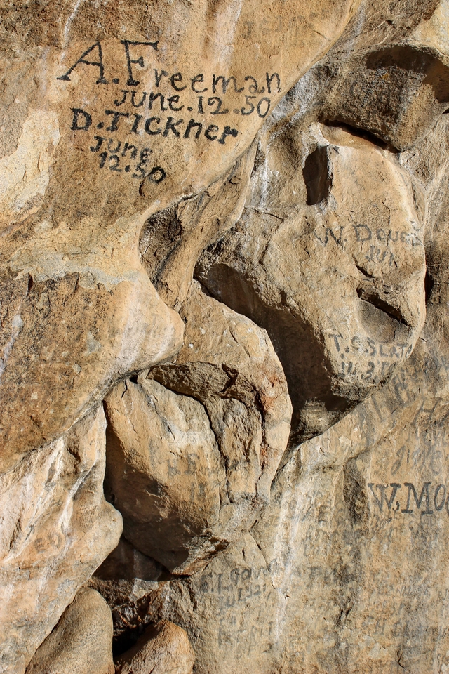 Emigrant signature written with axle-grease on granite
