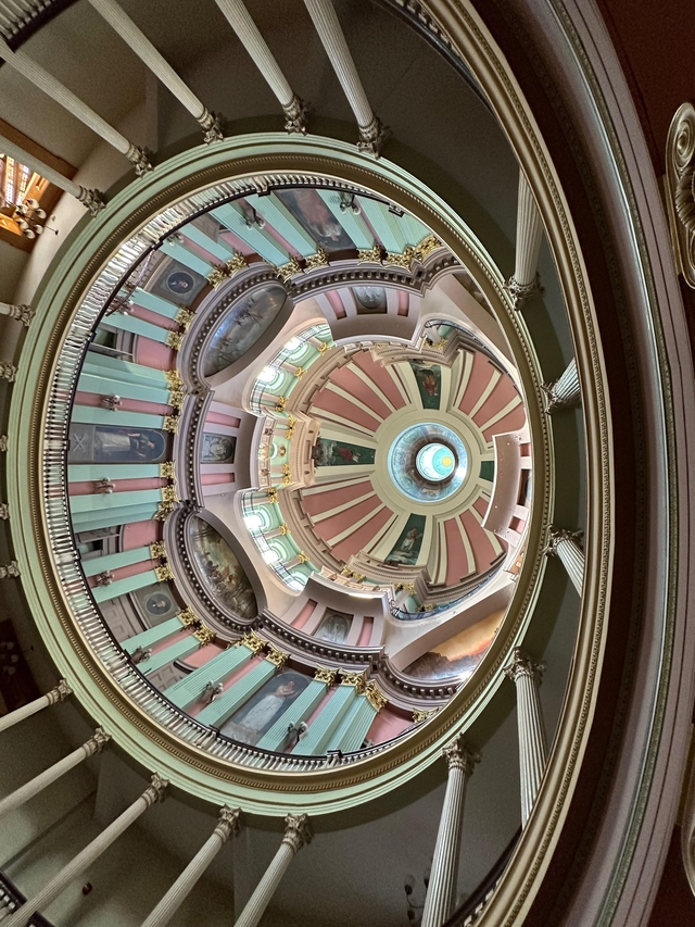 looking up at a very ornate decorated ceiling of many levels