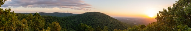 Sun setting over rolling hills