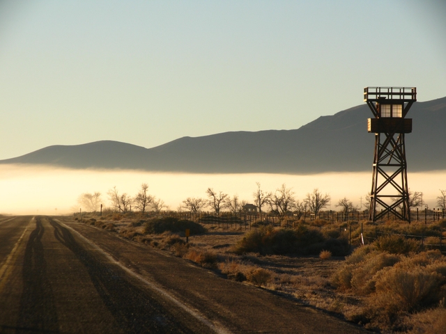 guard tower with fog and hills in background