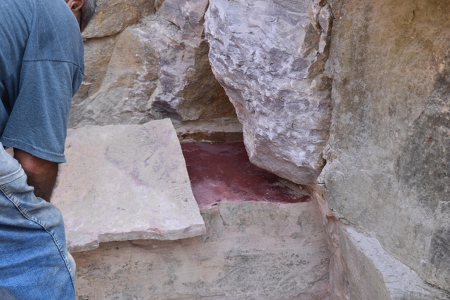 A sheet of stone being taken off a thick slab of stone in a quarry pit