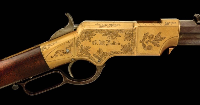 The receiver of an 1864 rifle shows decorative engraving with the original owner's name