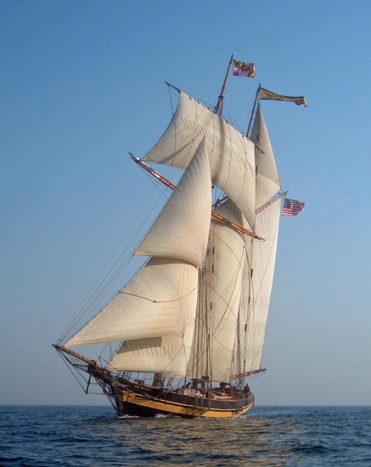 A tall ship sails on the water.