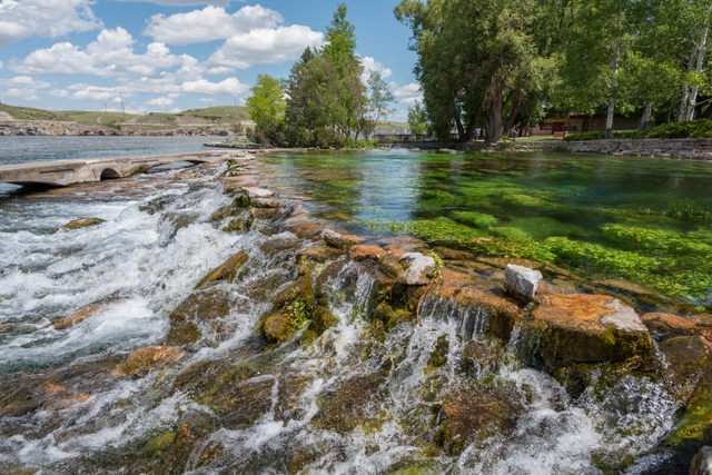 Small waterfall with brown rocks and green moss