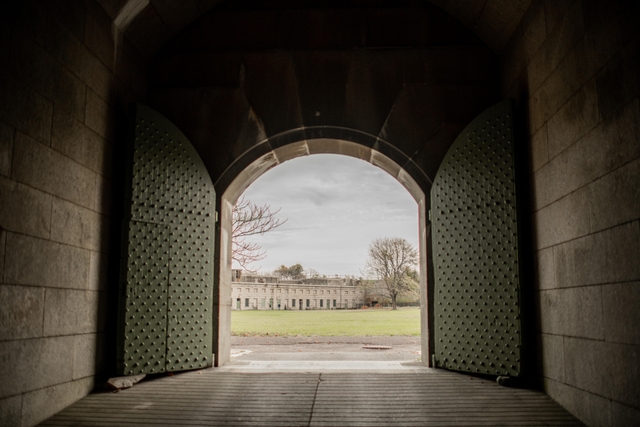 A big arched door opens to the parade ground of Fort Warren.