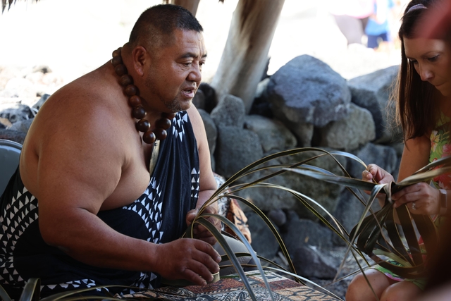 Man demonstrating Hawaiian craft