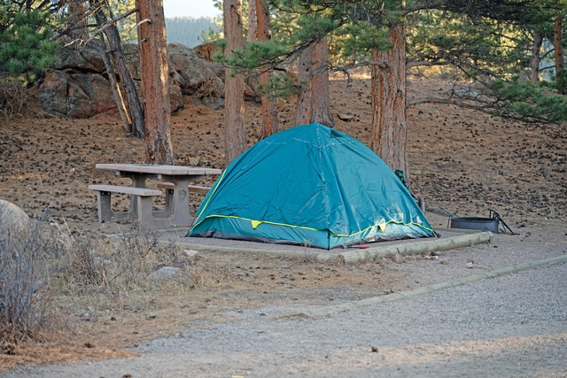 A tent is set up on a tent pad in a campsite in early winter in RMNP